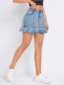 Close-up detail of high-waisted ruffled denim mini skirt with light wash finish