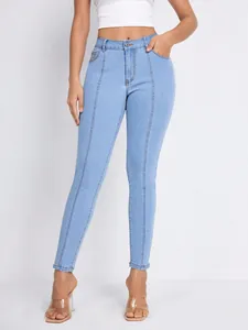 Detail of high-waisted blue skinny jeans with slimming front seam lines for women
