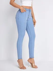 Detailed side view of high-waisted light blue skinny jeans with unique front seam detail.