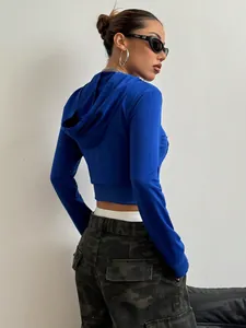 Rückansicht einer stylischen blauen bauchfreien Kapuzenjacke für Damen im Street-Style.