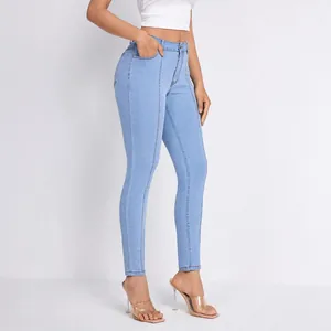 High-waisted light blue skinny jeans for women featuring front seam detailing and slimming fit.