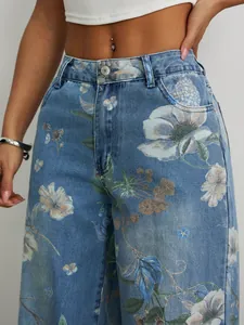 Close-up detail of high-waisted light blue denim jeans with vintage floral print