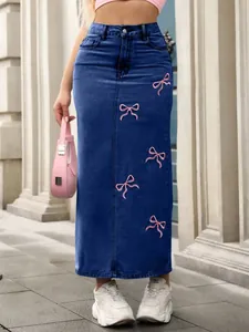 Detailed close-up of a long blue denim skirt featuring delicate pink bow embroidery