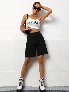 Close-up of women's black loose casual washed denim knee-length shorts on model
