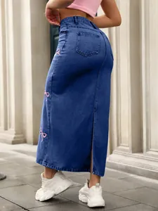 Detailed back view of a high-waisted denim maxi skirt with pink bow embroidery details