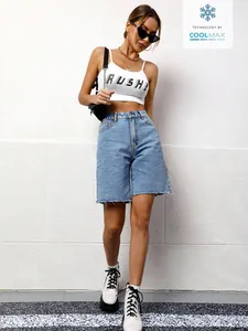 Full view of light wash denim shorts showing high-waist fit and casual raw hem detail.