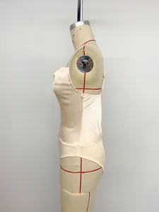 Detailed side profile of an elegant champagne satin bodysuit with pearl beaded straps.