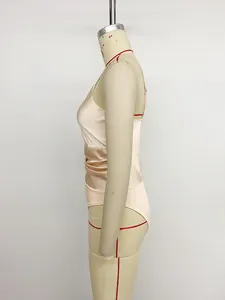 Side view of a champagne satin bodysuit showing the slim fit and draped waist details.