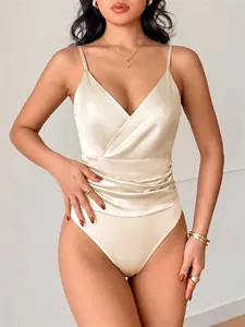 Detailed shot of a champagne satin sleeveless bodysuit featuring a stylish wrap V-neckline.