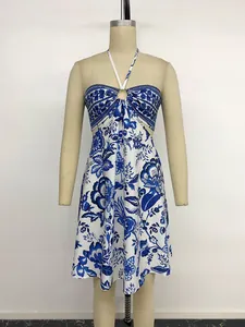 Front view of blue and white ethnic floral halter dress with metal ring detail and open back