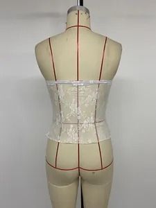 Detailed back view of white floral lace see-through tube top on a dress form