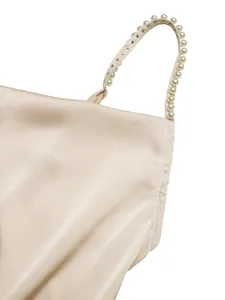 Close-up detail of a champagne satin bodysuit with elegant pearl-beaded shoulder straps.