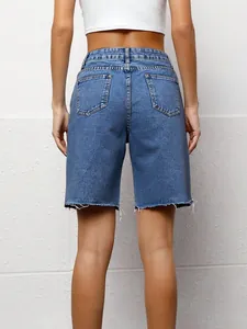 Back view of women's casual loose blue denim bermuda shorts with raw edges and pockets