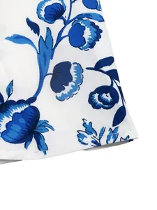 Macro detail of elegant blue floral print on white ethnic style summer dress fabric material