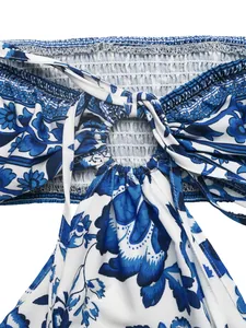 Detail view of blue floral halter dress with smocked bodice and center ring cutout
