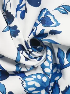 Macro detail of blue and white ethnic floral pattern fabric showing smooth twill texture