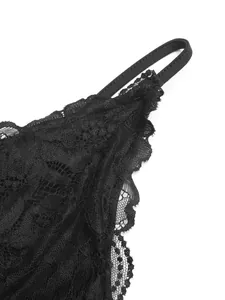 Close-up detail of black floral lace bodysuit showing delicate scalloped edge texture