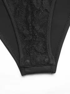 Detailed close-up of black lace bodysuit featuring snap button closure at the crotch