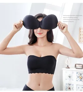 Detail view of a black strapless bra with moisture-wicking breathable pads held by model