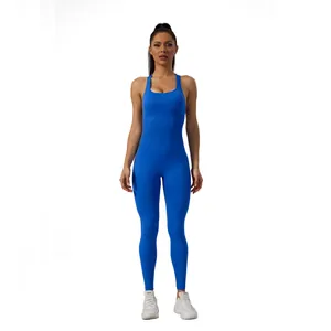 Full-length view of a woman in a royal blue seamless one-piece yoga jumpsuit.