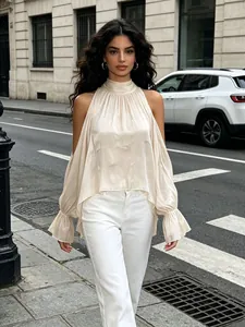 Elegante cremefarbene schulterfreie Bluse mit langen Rüschenärmeln am Straßenmodell.
