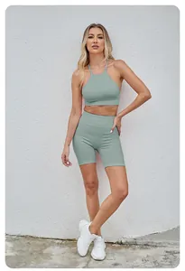 Macro view of sage green seamless yoga set featuring halter bra and high-waist shorts.