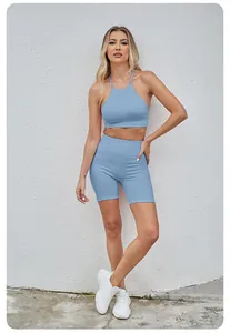Two-piece blue seamless yoga set featuring halter sports bra and lifting biker shorts