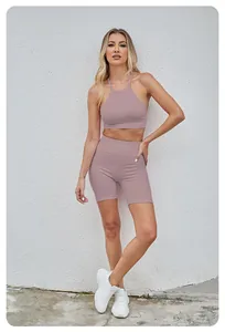 Full body view of mauve seamless yoga set with halter sports bra and high-waisted shorts