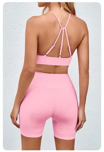 Back view of a seamless pink yoga set featuring a strappy sports bra and high-waisted shorts.