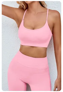 Close-up detail of a pink seamless yoga set featuring sports bra and high-waisted shorts.