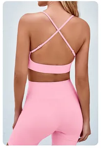 Back view of pink seamless yoga set featuring a cross-strap bra and high-waist shorts