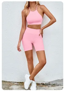 Pink seamless yoga set featuring a halter sports bra and high-waisted fitness shorts