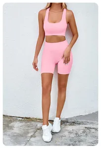 Full length view of a pink seamless yoga set with sports bra and lifting shorts on a model