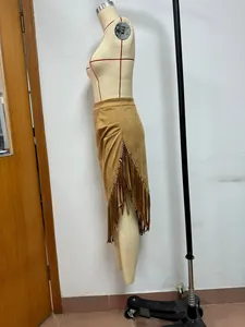 Macro view of solid color suede midi skirt featuring western style fringe detail.