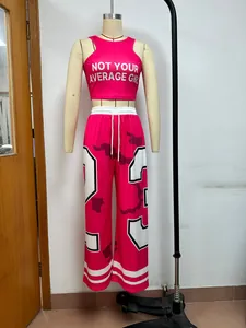 Two-piece pink street style set featuring printed tank top and matching wide leg pants