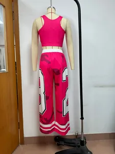Back view of pink two-piece set with camo print wide-leg pants on mannequin.