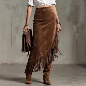 Detailed view of a brown suede midi skirt featuring western fringe and asymmetrical hem.