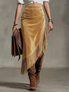 Detail of mustard yellow suede fringe skirt with asymmetrical western vintage design.
