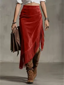 Detail showing the long fringe hem and suede texture of a Western style red skirt