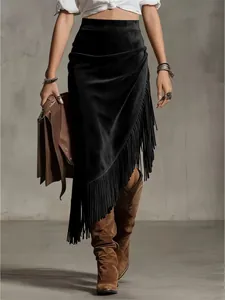 Detail view of vintage Western-style black suede skirt with irregular fringe hem line