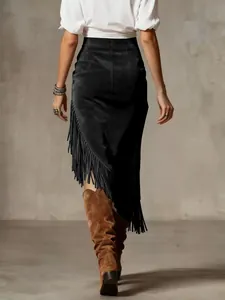 Detailed view of black suede midi skirt with Western fringe and asymmetric hem design