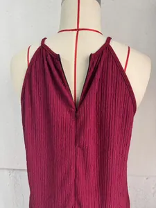 Detailed macro view of the back zipper and crinkled fabric on a wine red jumpsuit
