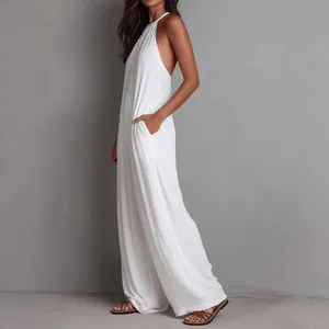 Full-length side view of a white pleated halter-neck wide-leg jumpsuit on model