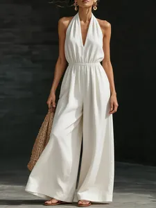 Elegante mono blanco con cuello en V, halter y pernera ancha para un estilo veraniego