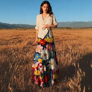 Elegante bohemian maxi-rok met bloemenprint gedragen door model in een gouden veld.