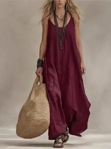 Elegant bohemian wine red sleeveless maxi dress styled with ethnic jewelry and straw bag