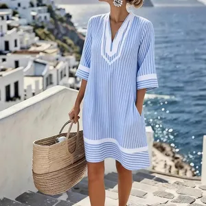 Relaxed blue and white striped V-neck beach dress with a chic resort style for summer