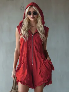 Model wearing a red vintage hooded sleeveless cotton linen romper with front zip detail