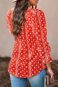 Rear view detail of a red floral long sleeve blouse with geometric diamond patterns.