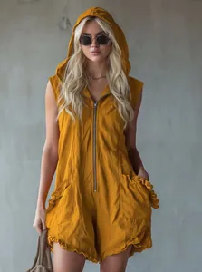 Detail showing a yellow hooded sleeveless cotton linen romper with a front zipper